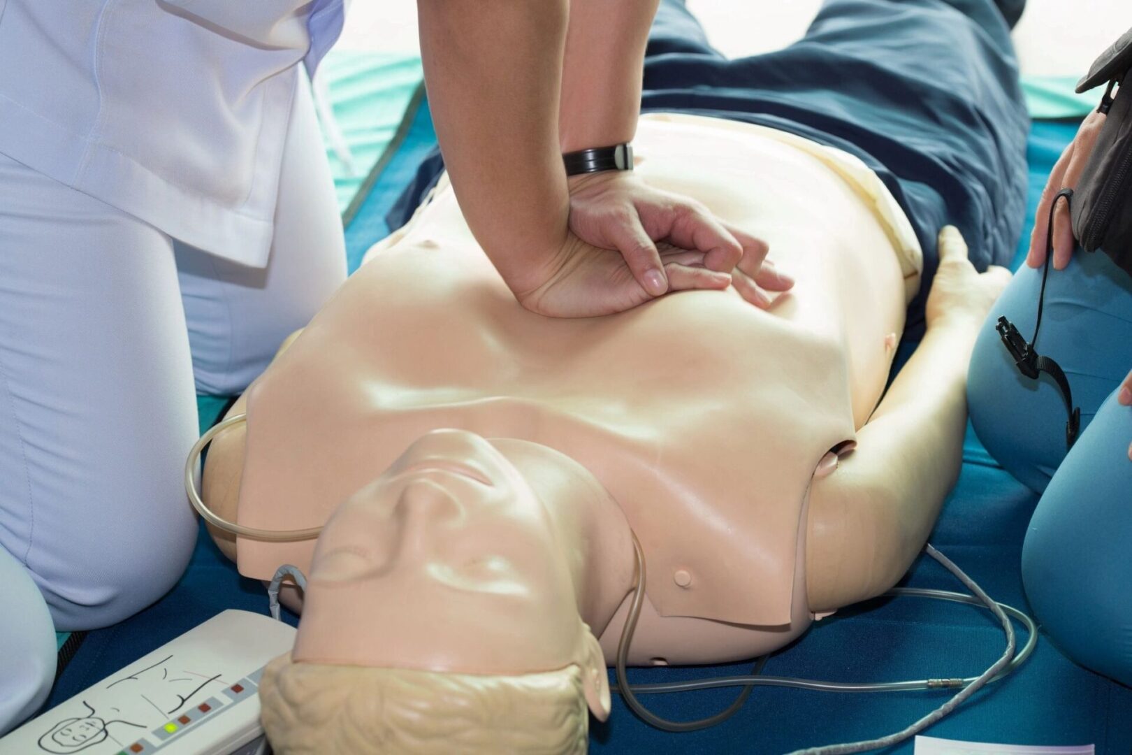 A person doing a CPR on a mannequin