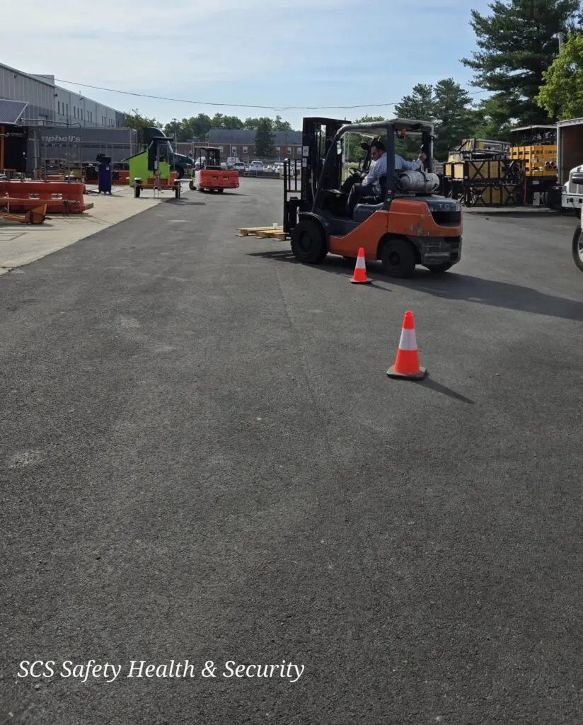 A forklift is parked on the side of the road.